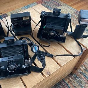 Vintage Polaroid cameras (3) with a carrying case.